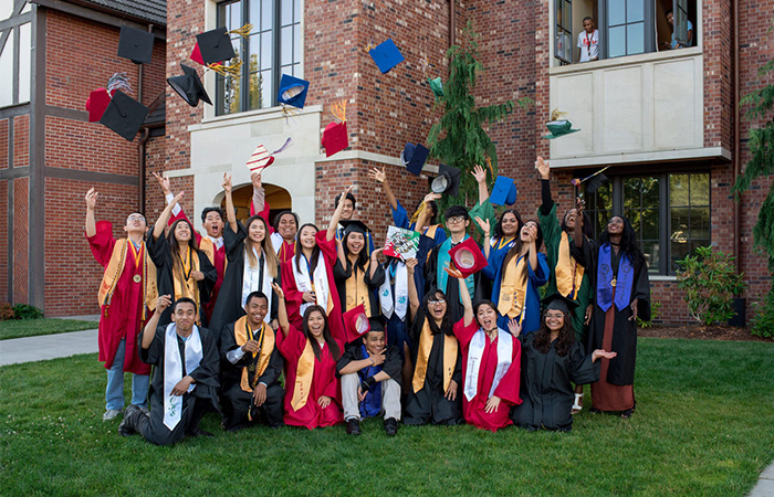 Students graduating throwing hats